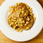 Gingerbread pancakes with a butter apple topping on a plate.