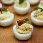 Bacon blue cheese deviled eggs on a wooden counter.