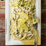 Lemon chicken pasta on a plate with a fork.