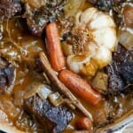 Red wine short ribs simmering in a Dutch oven.