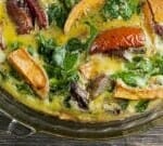 Roasted vegetable frittata in a pie plate.