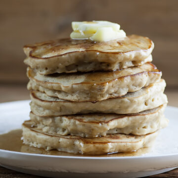A stack of cinnamon oat pancakes on a plate.