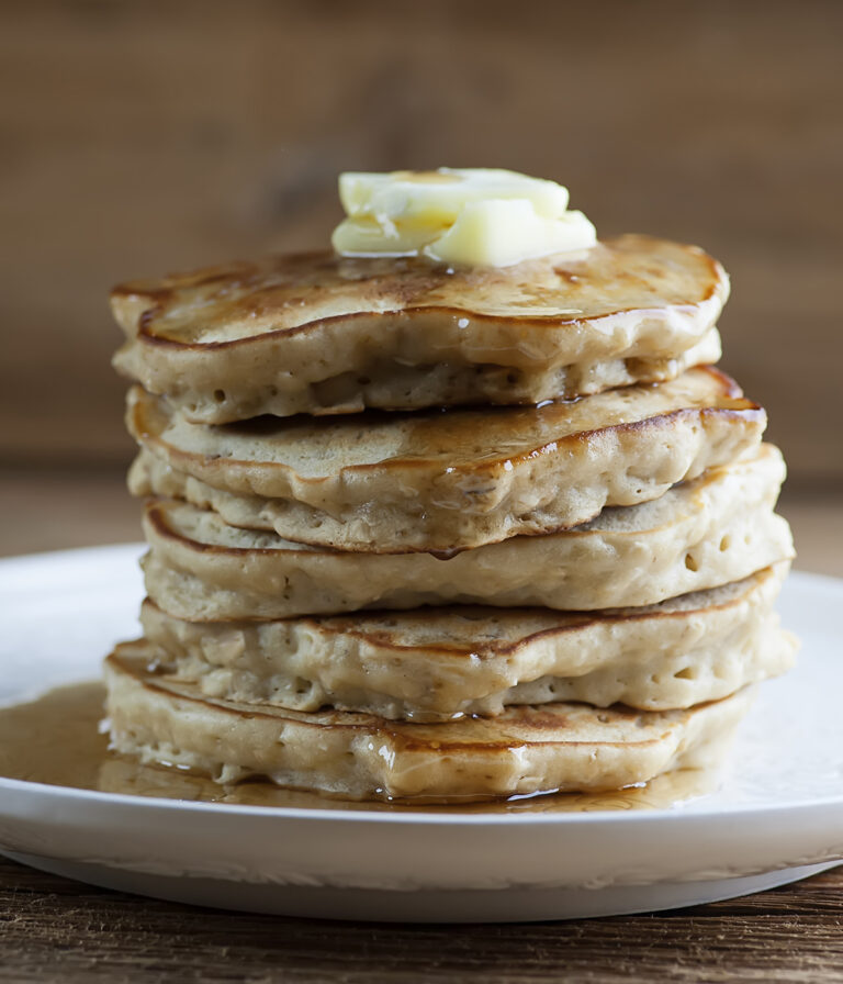 A stack of cinnamon oat pancakes on a plate.