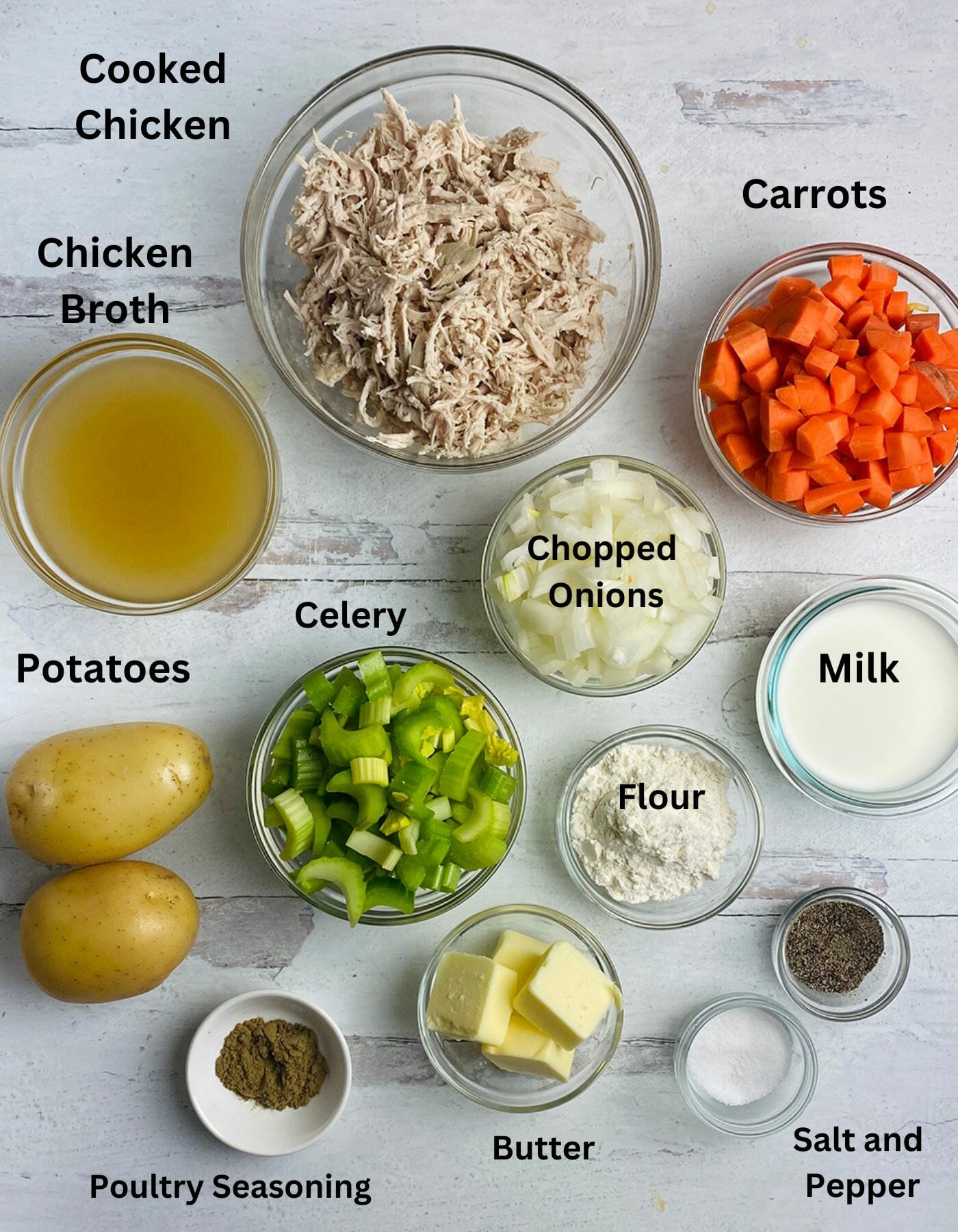 Ingredients for chicken pot pie with mashed potato crust on a wooden board.