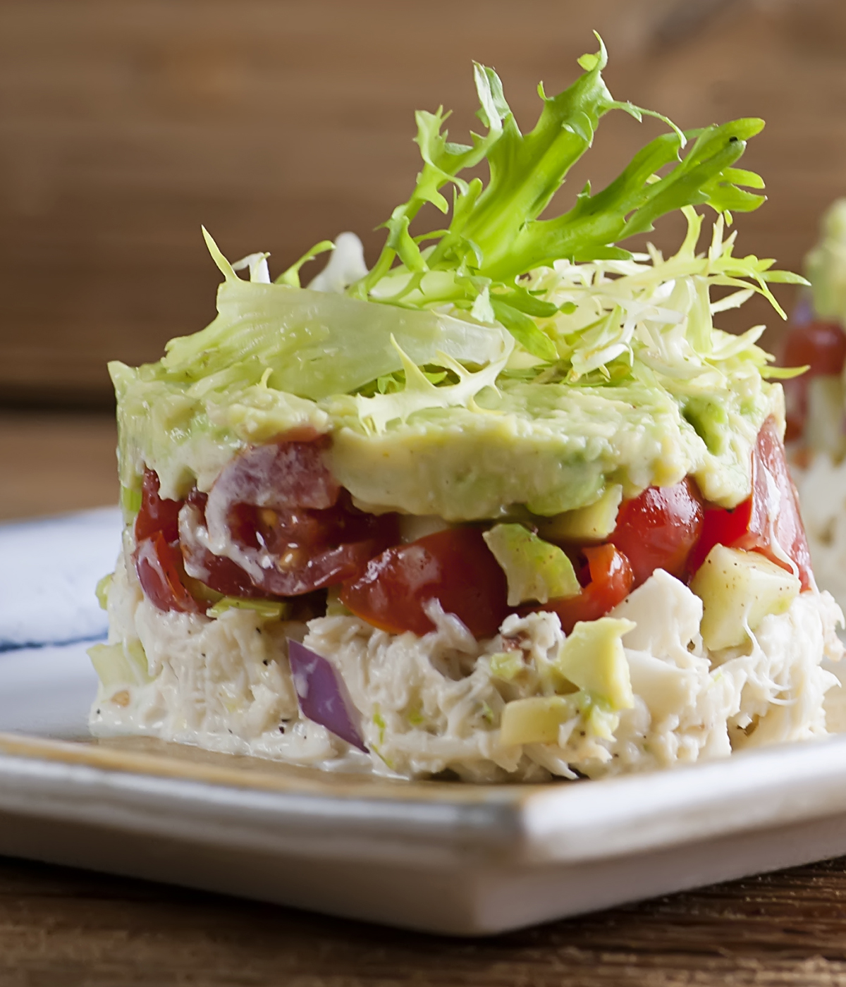 Crab tower with lettuce on top.