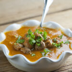 Tomato meatball soup in a bowl.