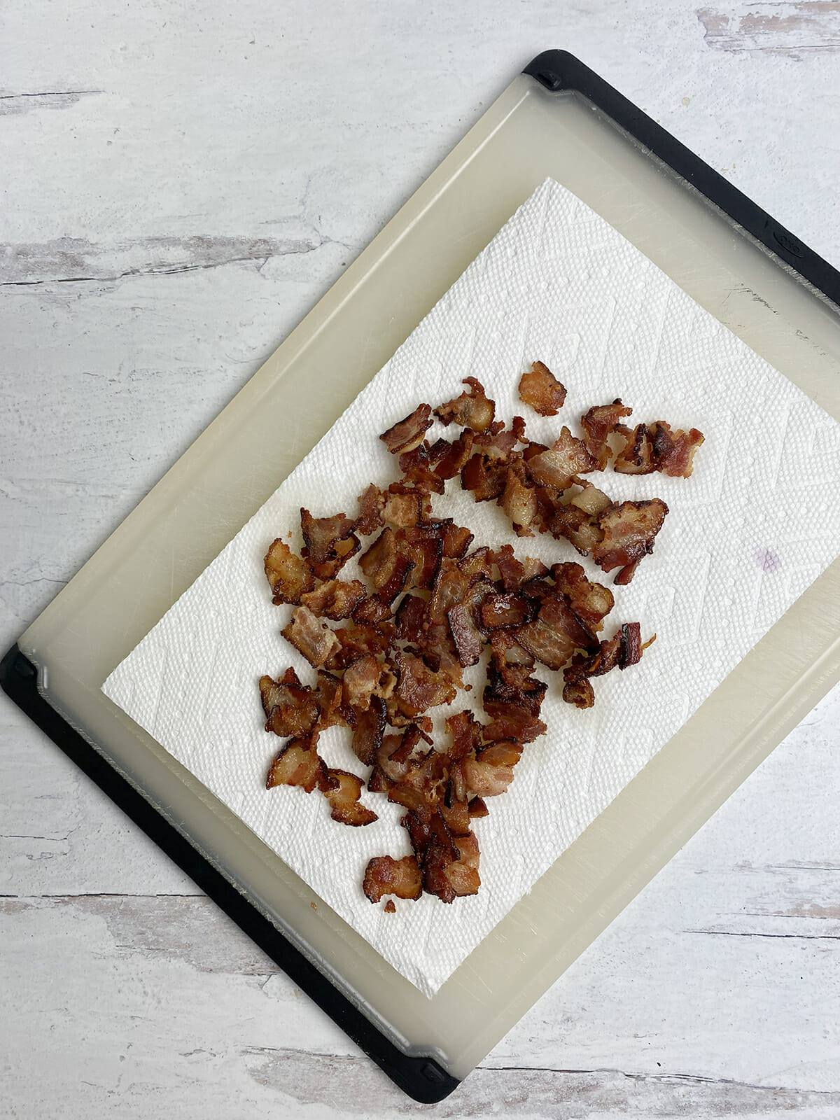 Bacon draining on paper towels.