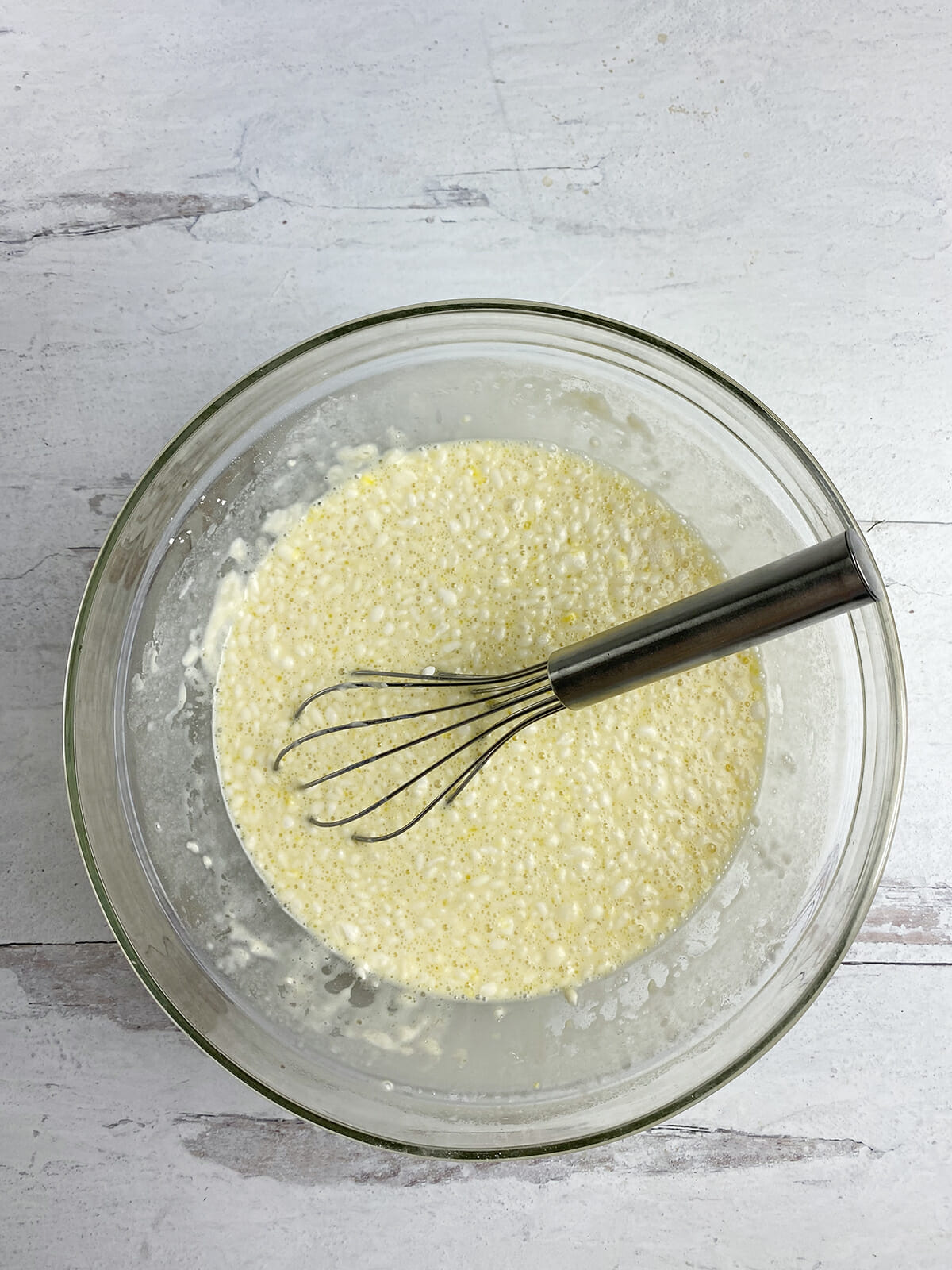 Whisked eggs, flour and butter in a mixing bowl.