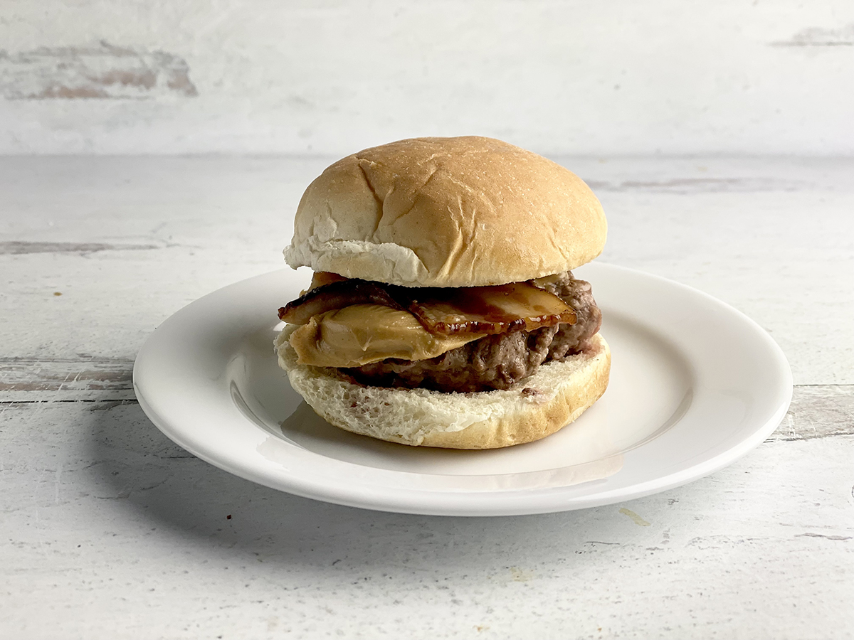 Peanut Butter Bacon Burger sitting on a plate.