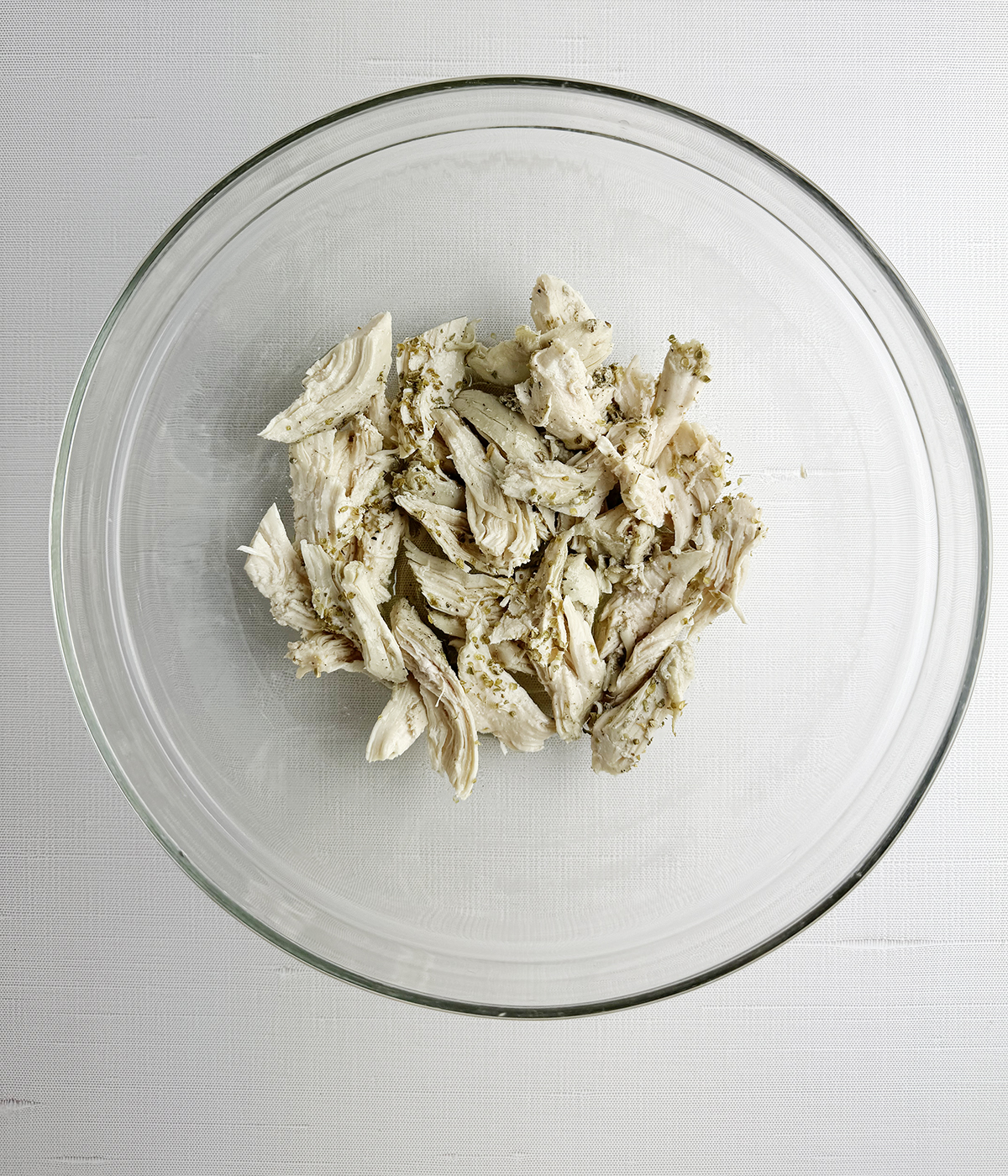 Chicken marinating in a bowl.