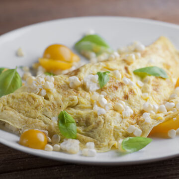 Farmer's Omelet on a plate on a wooden counter.