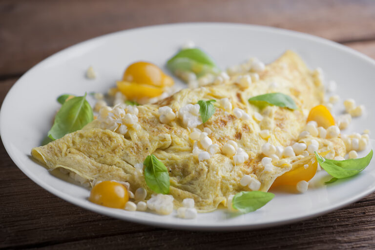 Farmer's Omelet on a plate on a wooden counter.