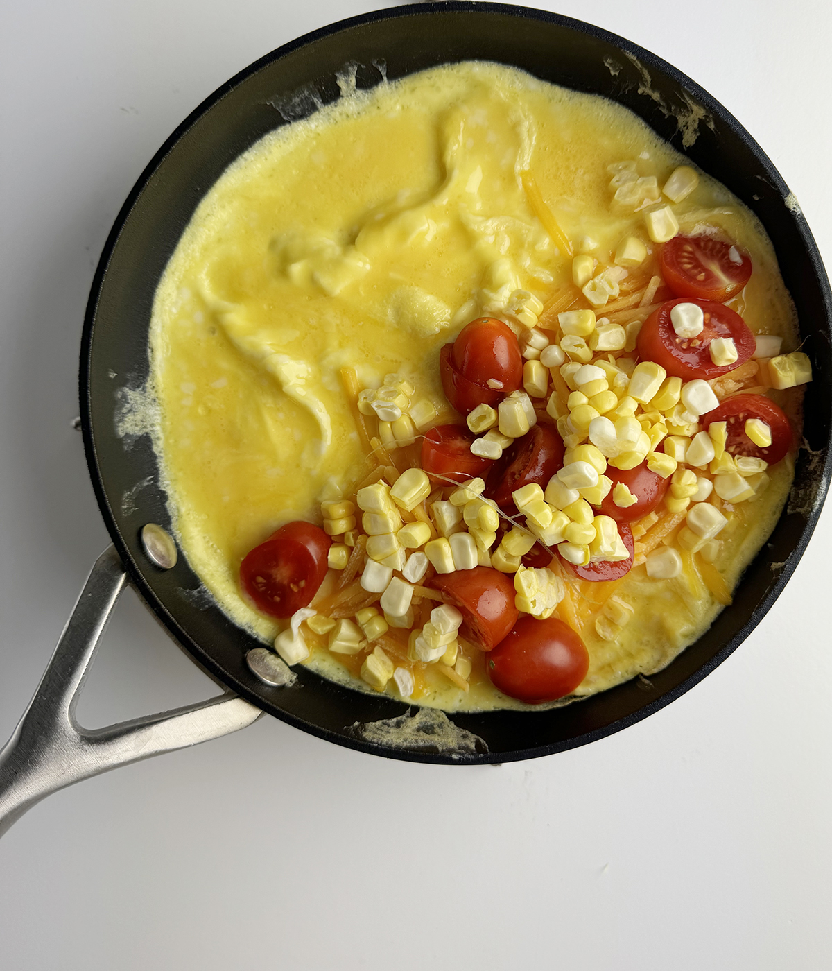 Farmer's omelet with cheese and vegetables inside.
