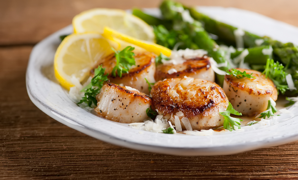 This easy recipe for scallops in lemon butter sauce makes a restaurant quality dinner in no time! Seared scallops in a delicate sauce topped with a dusting of parmesan cheese.