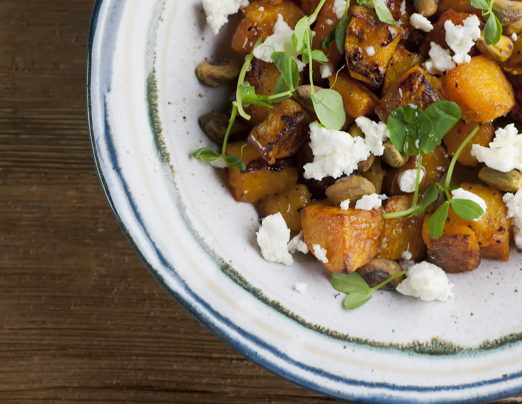 Roasted butternut squash with feta in a bowl.