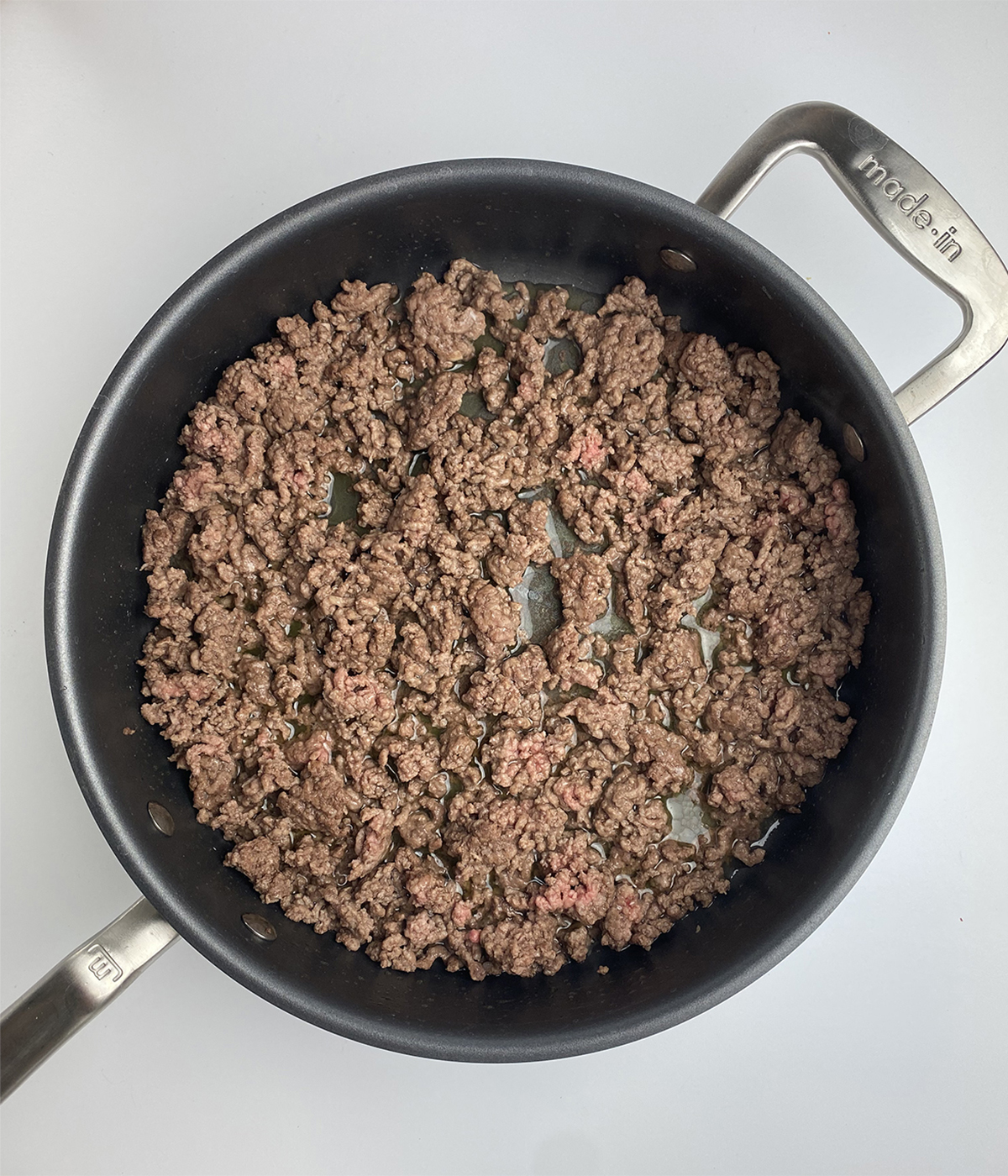 Cooked ground beef in a skillet.