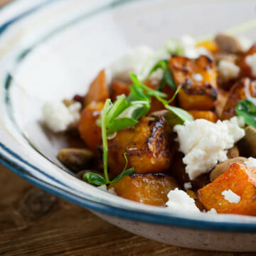 Roasted butternut squash with feta in a bowl.