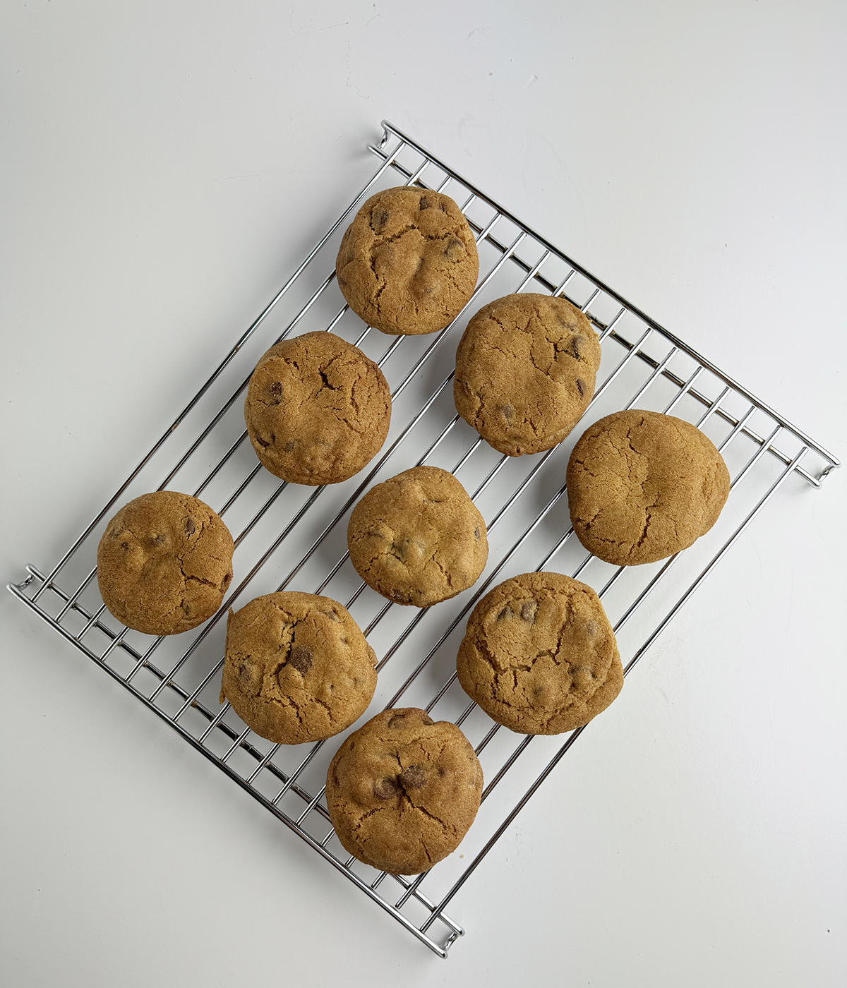 Cinnamon chocolate chip cookies cooling on a rack.