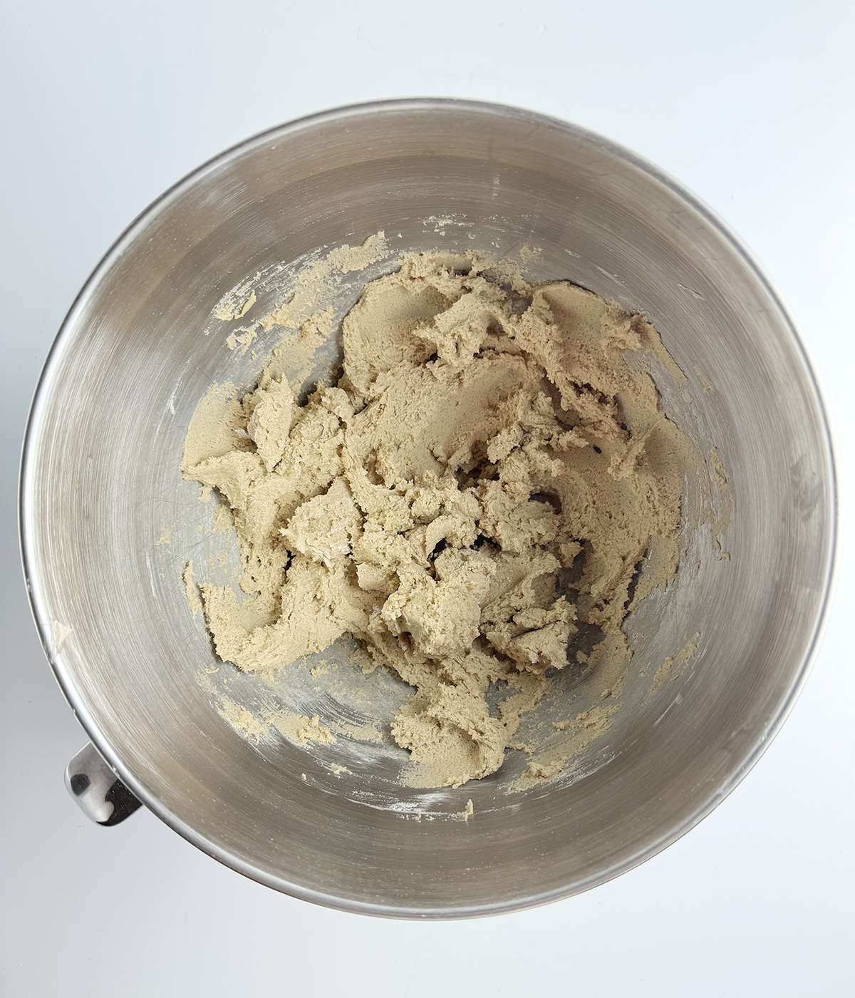 Sugar and butter and egg and flour mixture in a bowl.