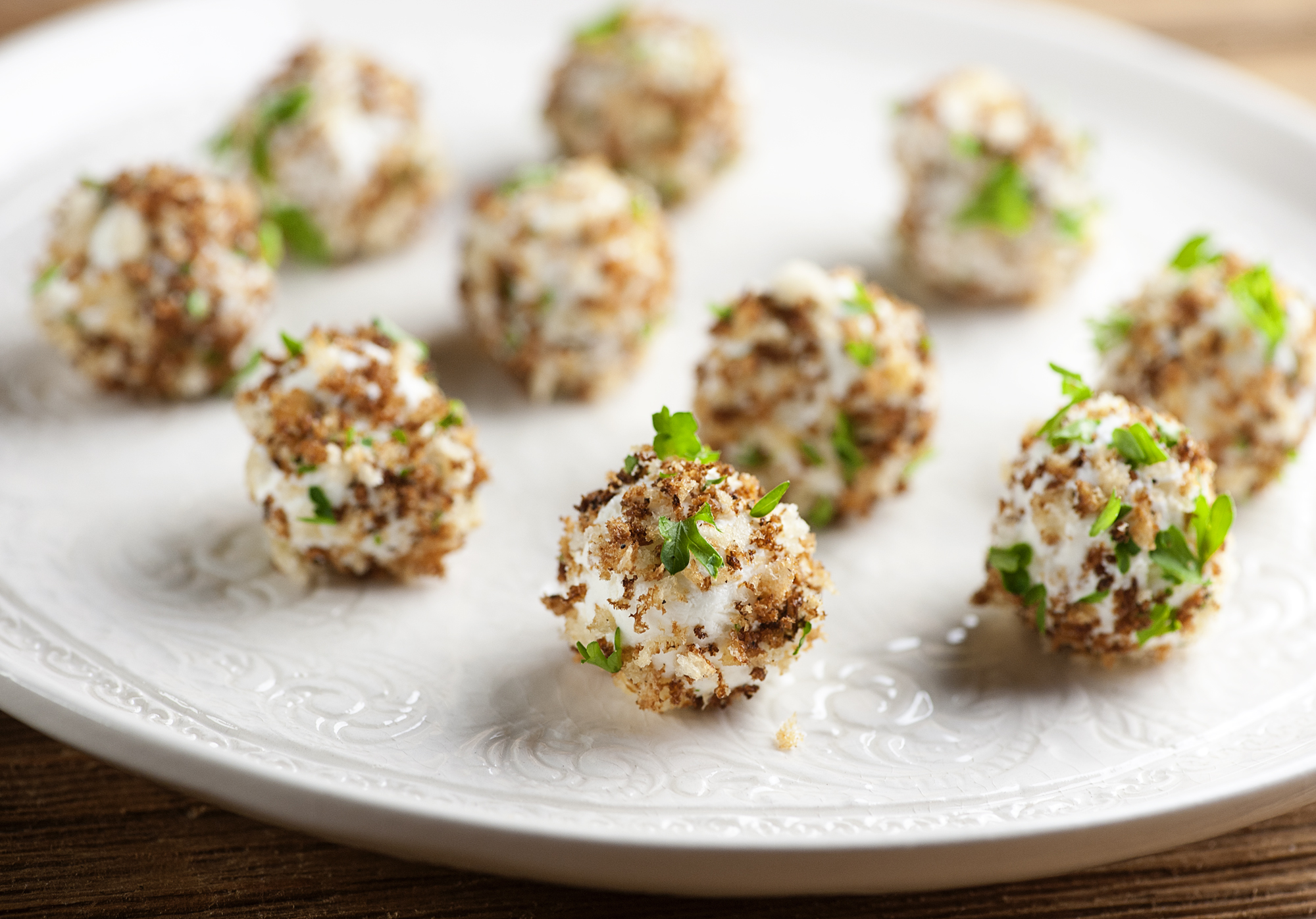Goat cheese truffles on a plate.