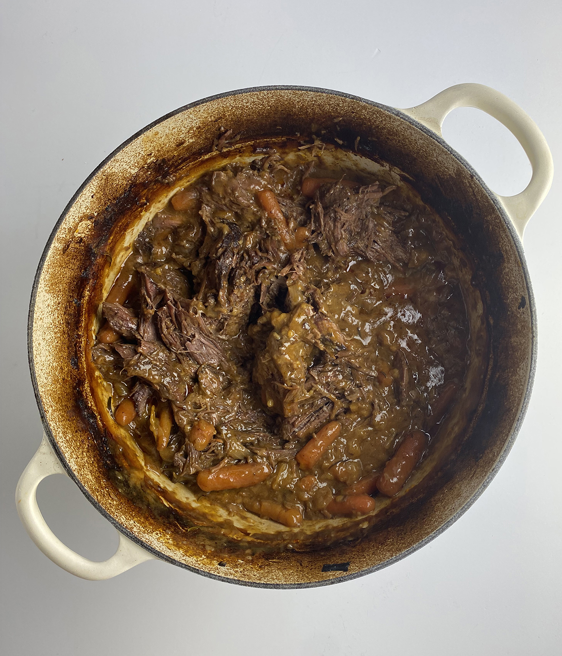 Shredded pot roast in a Dutch Oven.