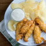 Easy potato chip chicken fingers on a plate.