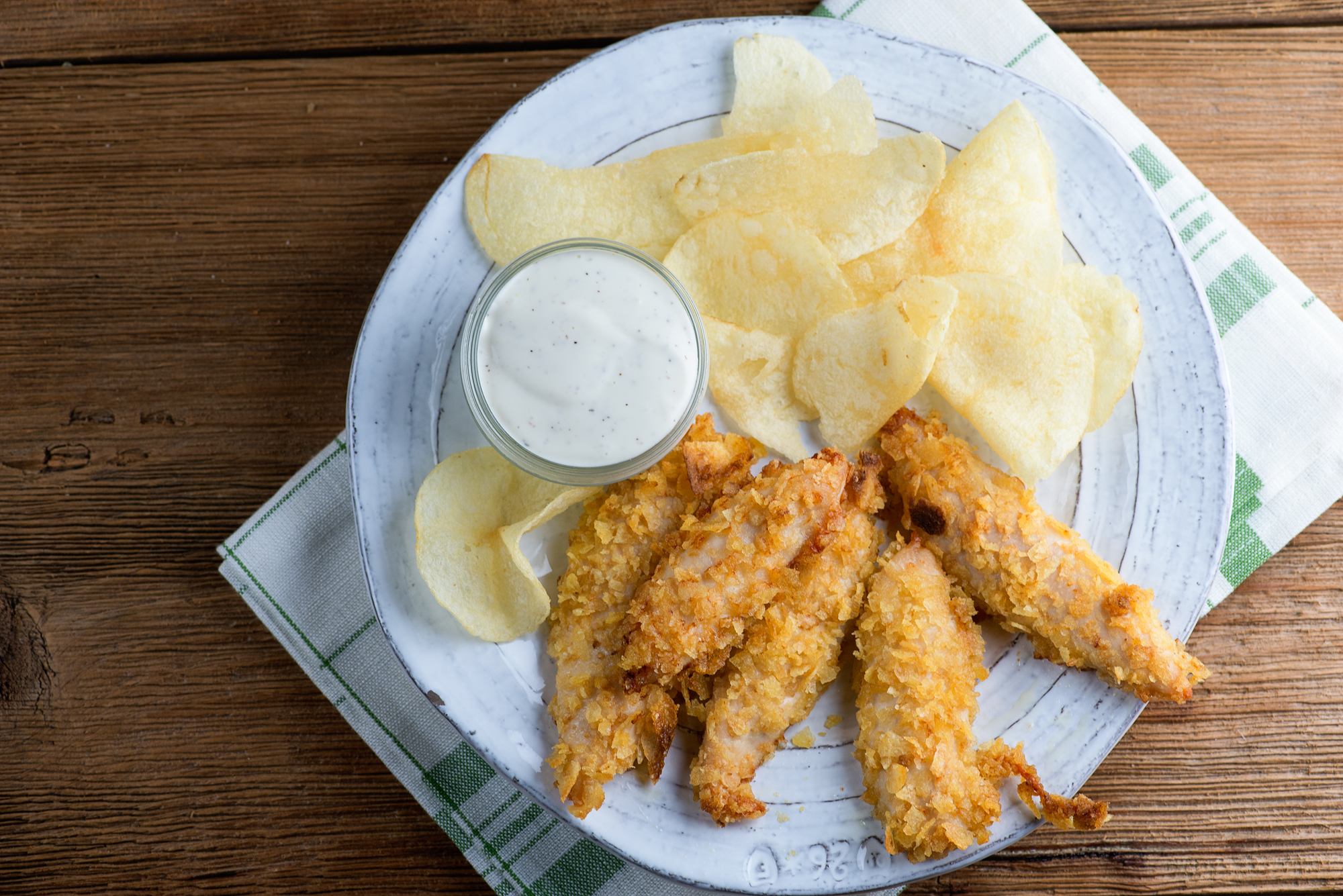 potato chip chicken fingers Potato Chip chicken fingers on a plate with potato chips.