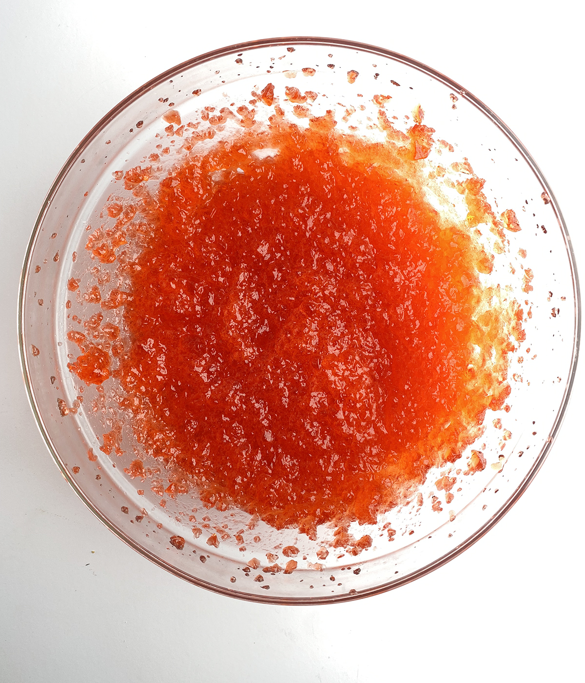 Whipped strawberry gelatin in a mixing bowl.