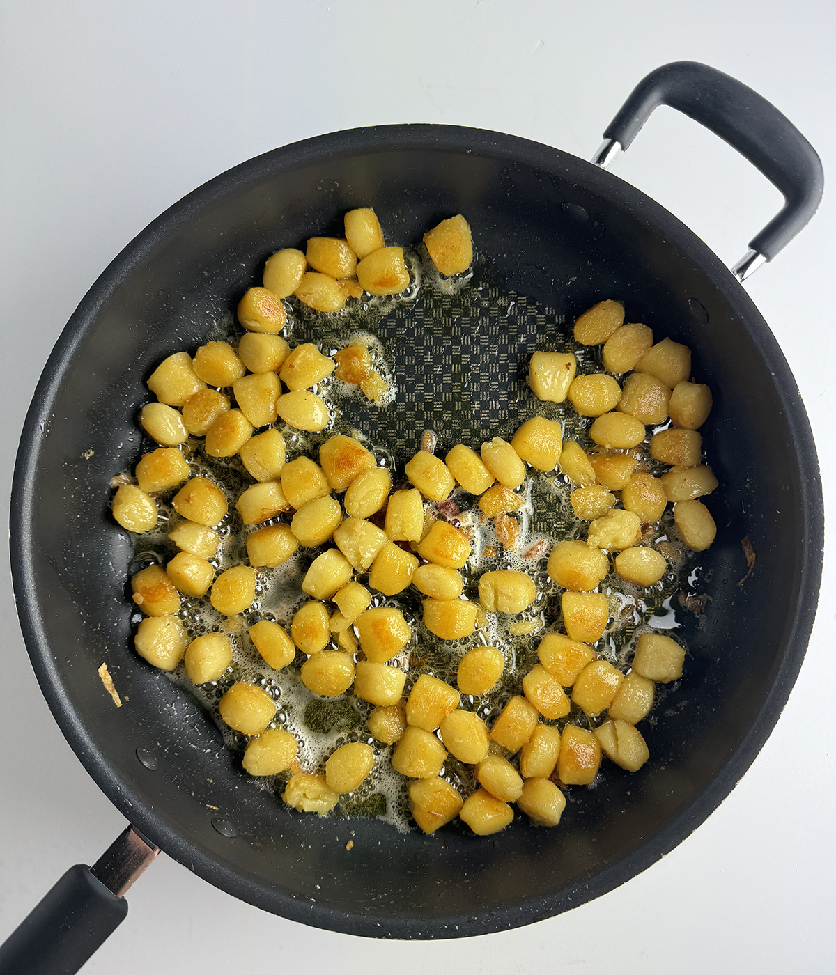 Gnocchi browning in a skillet