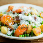 Gnocchi with spring vegetables on a plate.