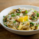 Bowl of brown butter pasta with egg.