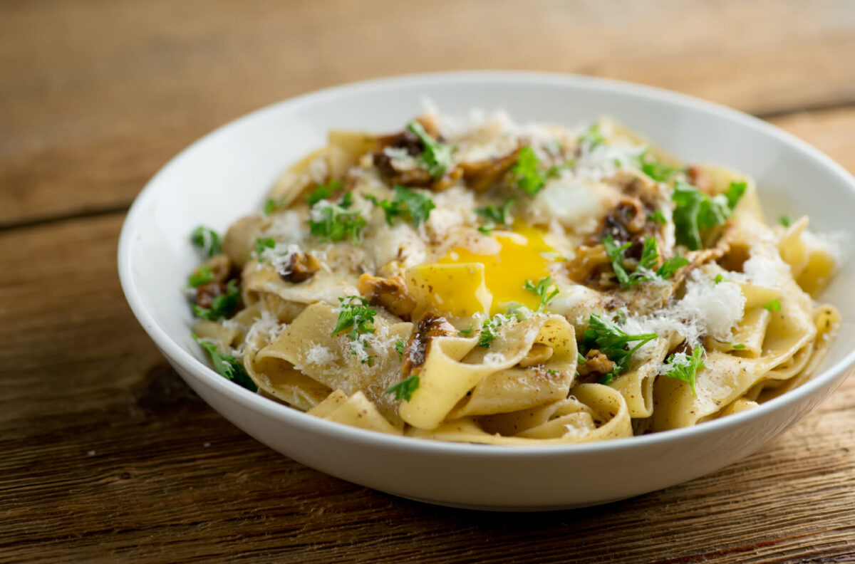 Bowl of brown butter pasta with egg.