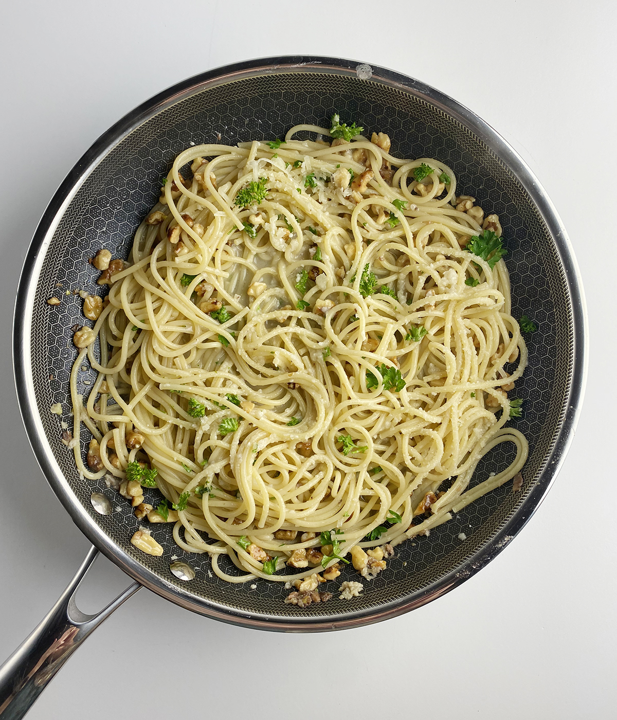 Pasta with anchovy sauce in a skillet.