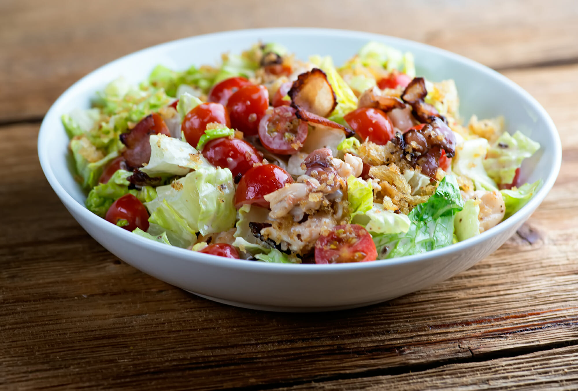 Lobster BLT salad in a bowl.