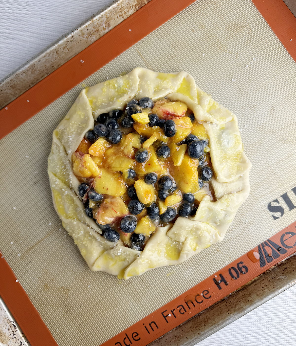 Blueberry peach tart ready for the oven.