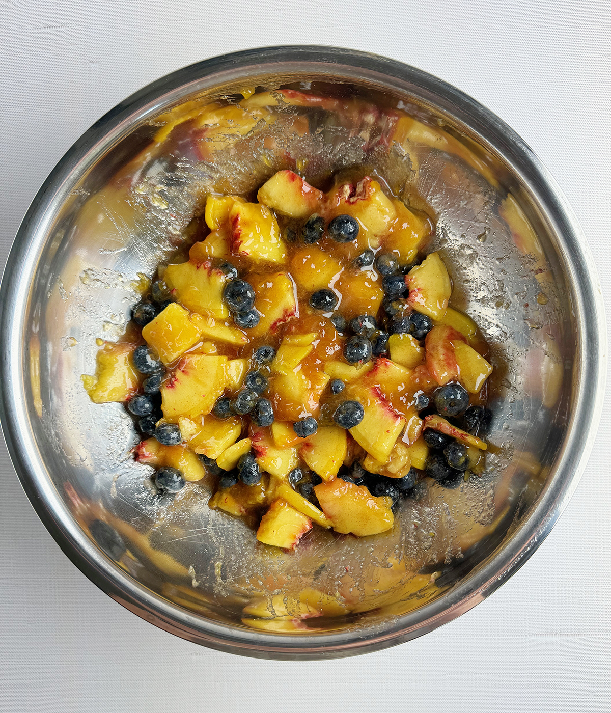 Peach and blueberry mixture on a bowl.