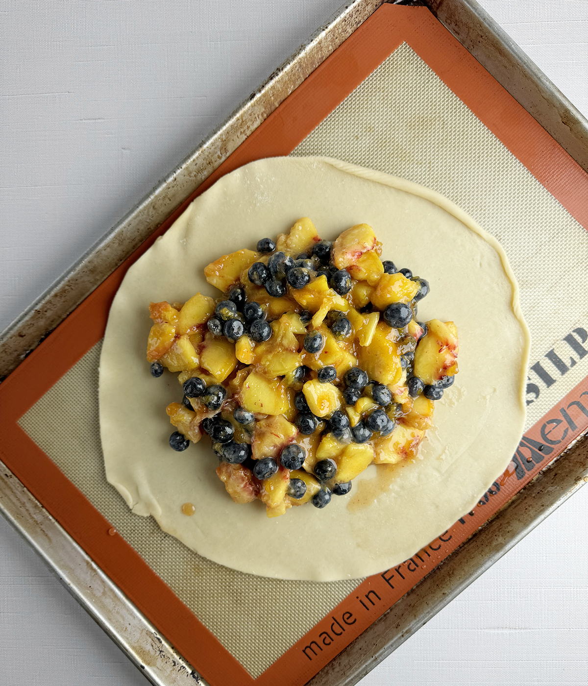 Peach and blueberry mixture on a pie crust.