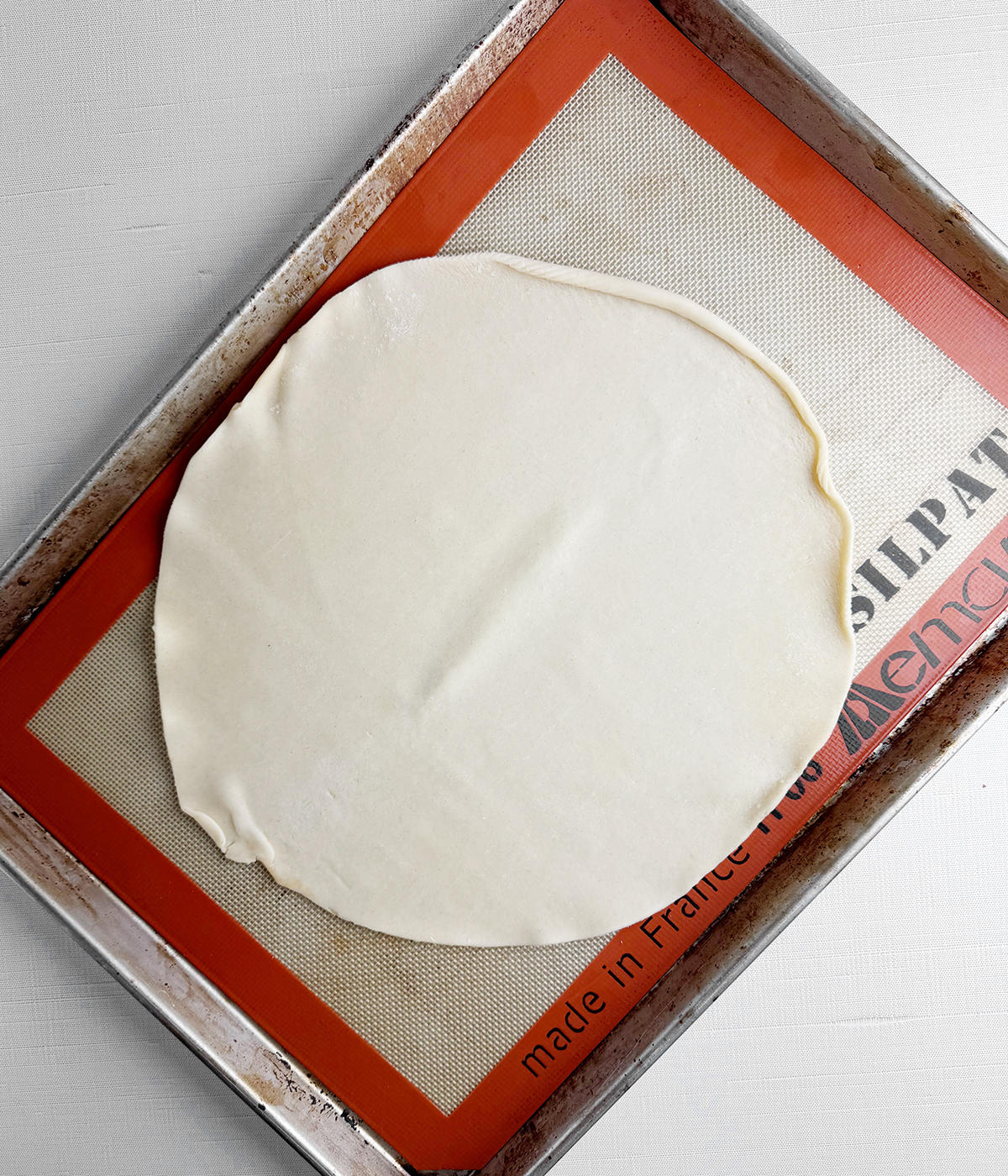 Pie crust on a baking pan.