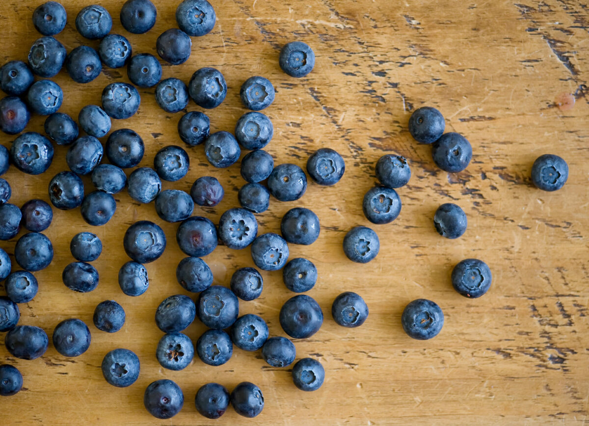 Blueberries on a wooden counter.