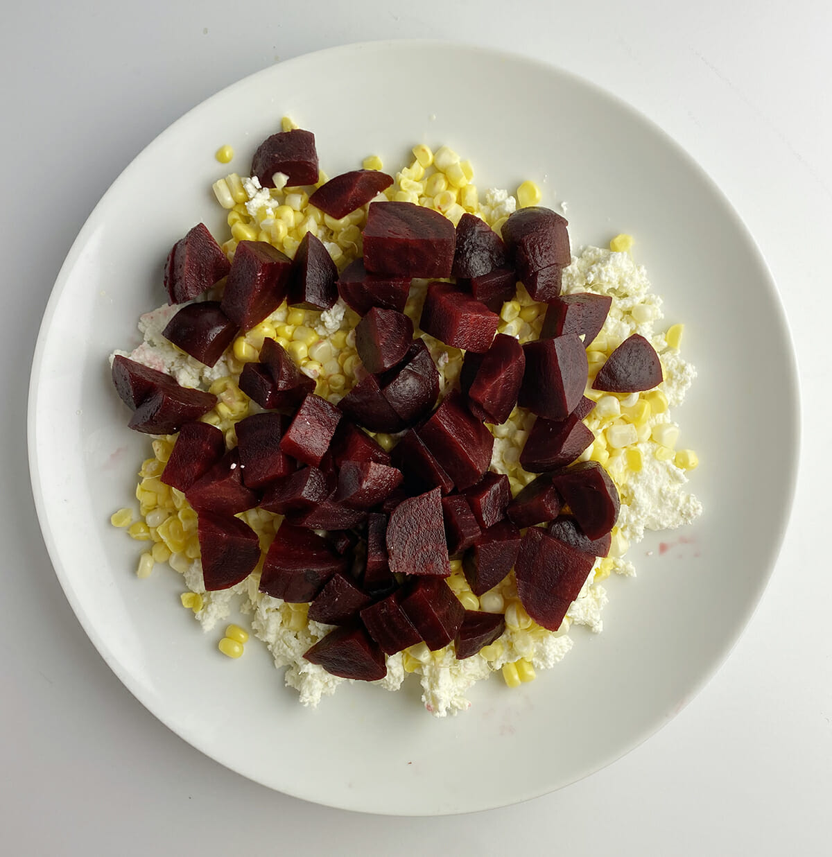 corn and beets over ricotta