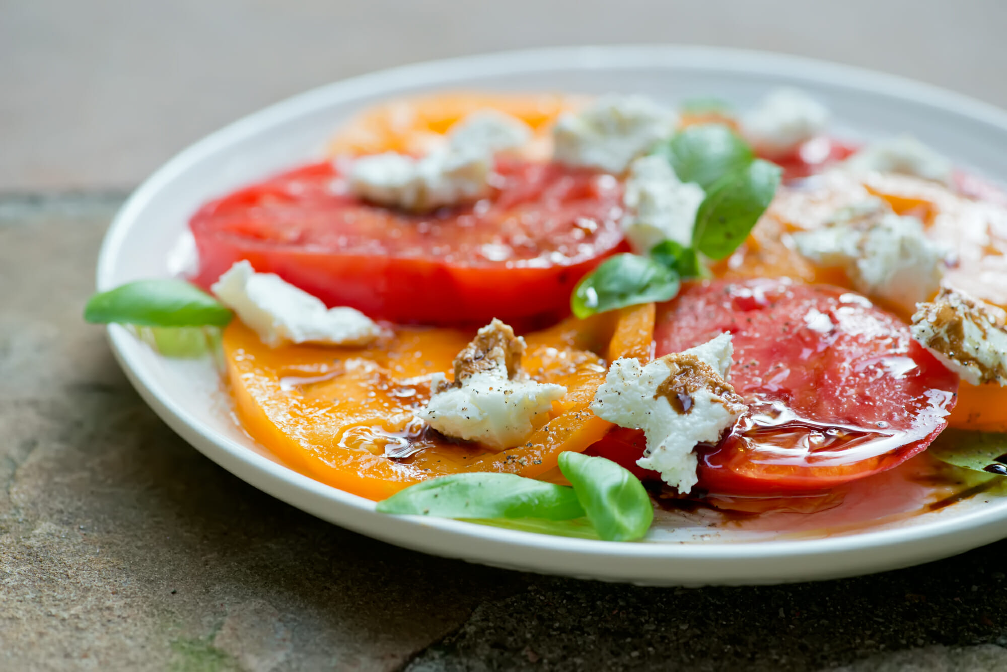 Tomato and goat cheese salad on a plate.