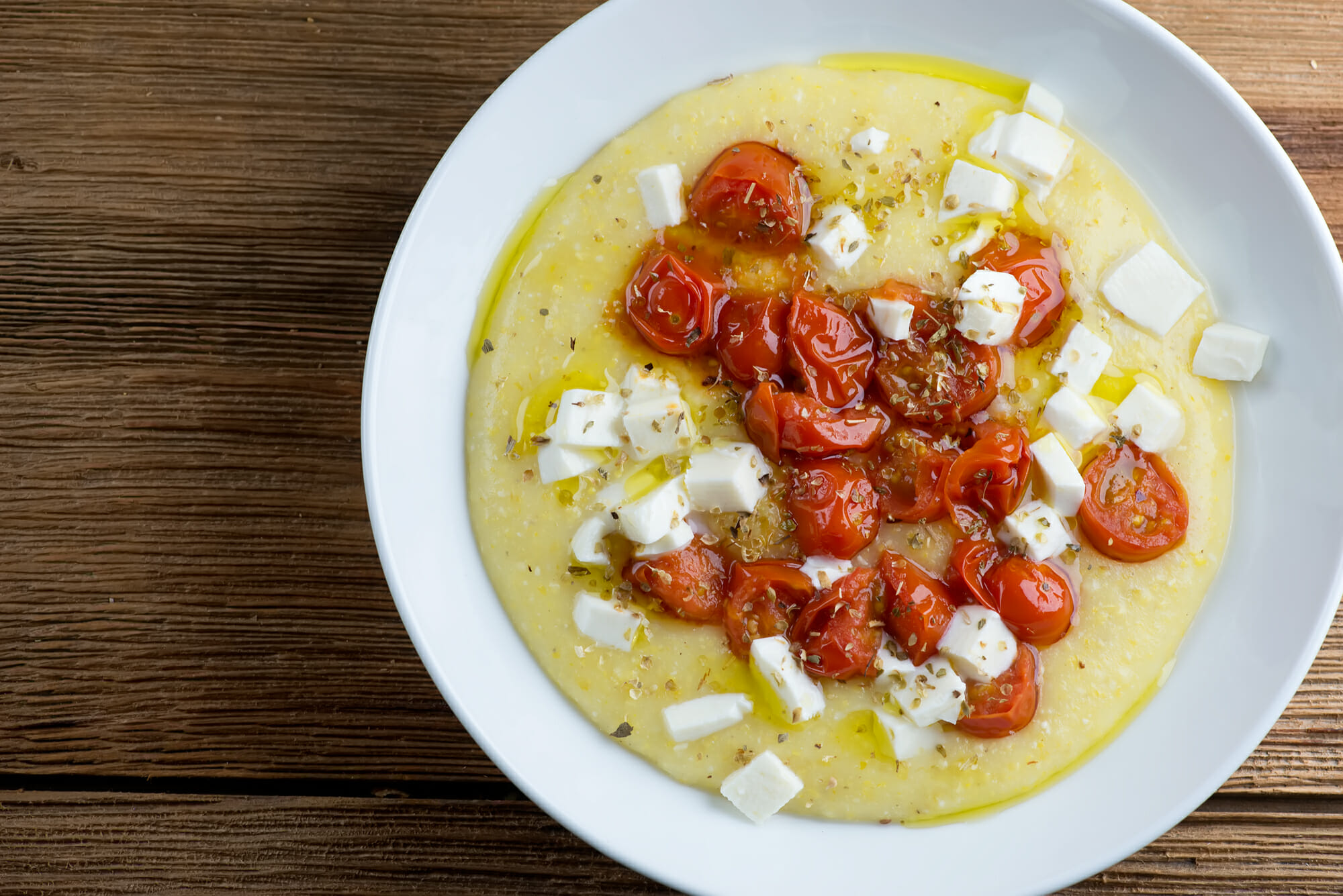 Tomato mozzarella polenta in a bowl.