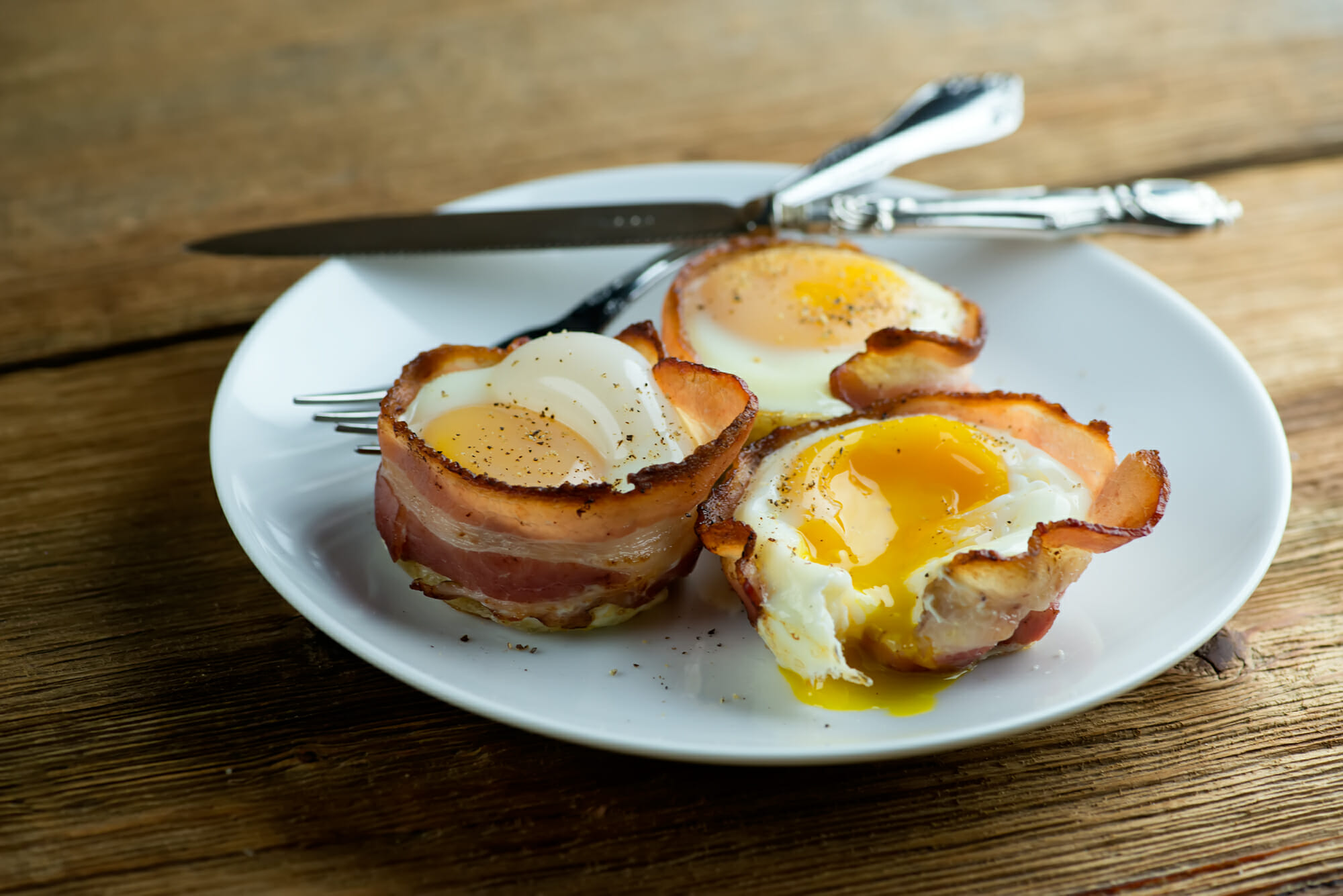 Bacon and egg muffins on a plate.