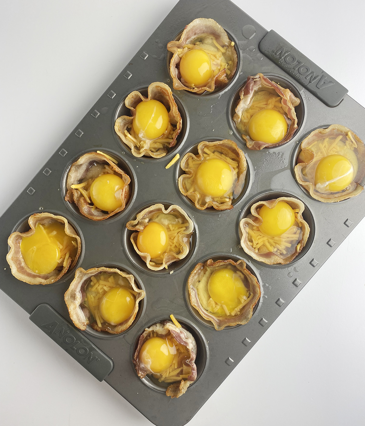 Bacon egg and cheese muffins ready for the oven.