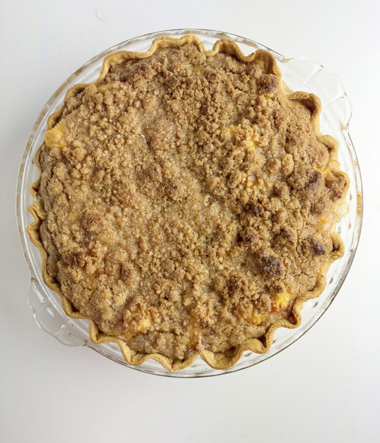 Baked fresh peach pie out of the oven.