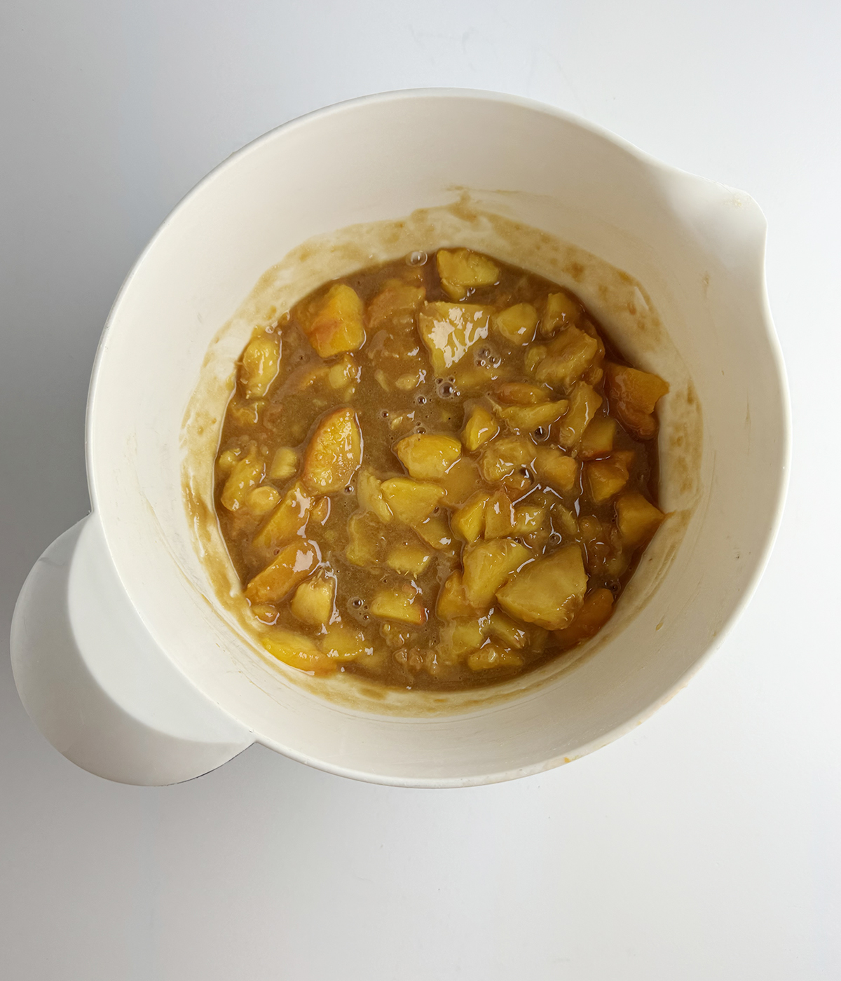 Fresh peach pie filling in a mixing bowl.