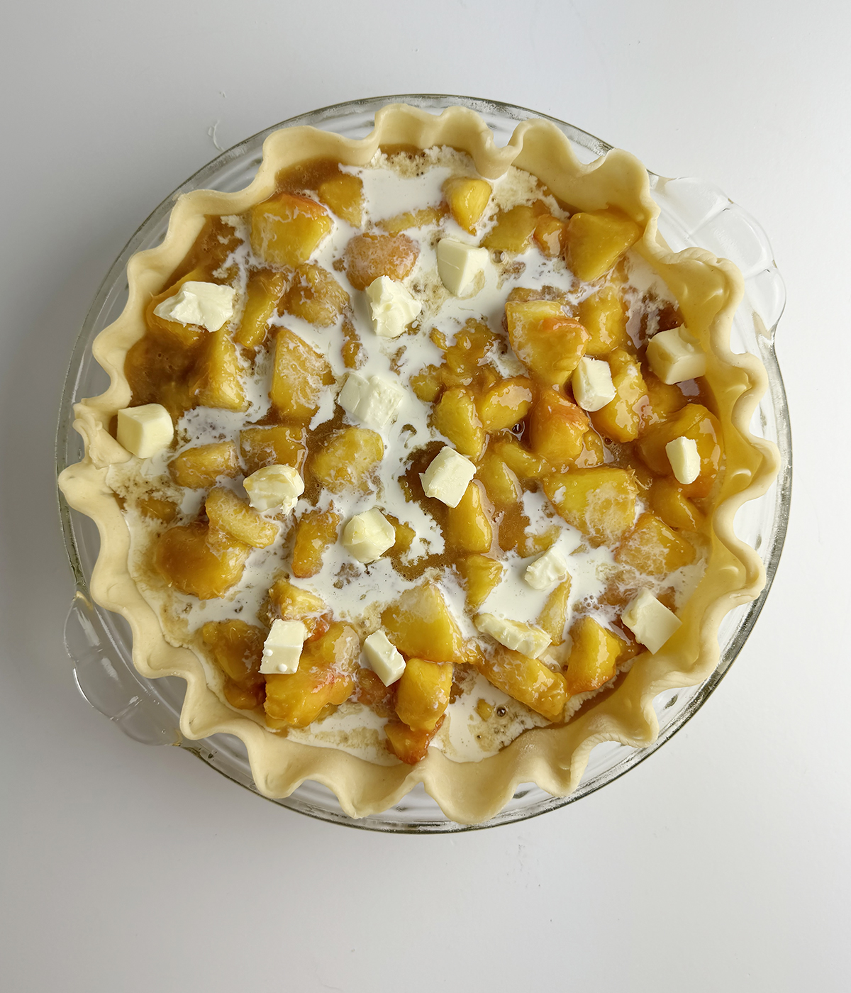 Fresh peach pie filling in a pie crust.