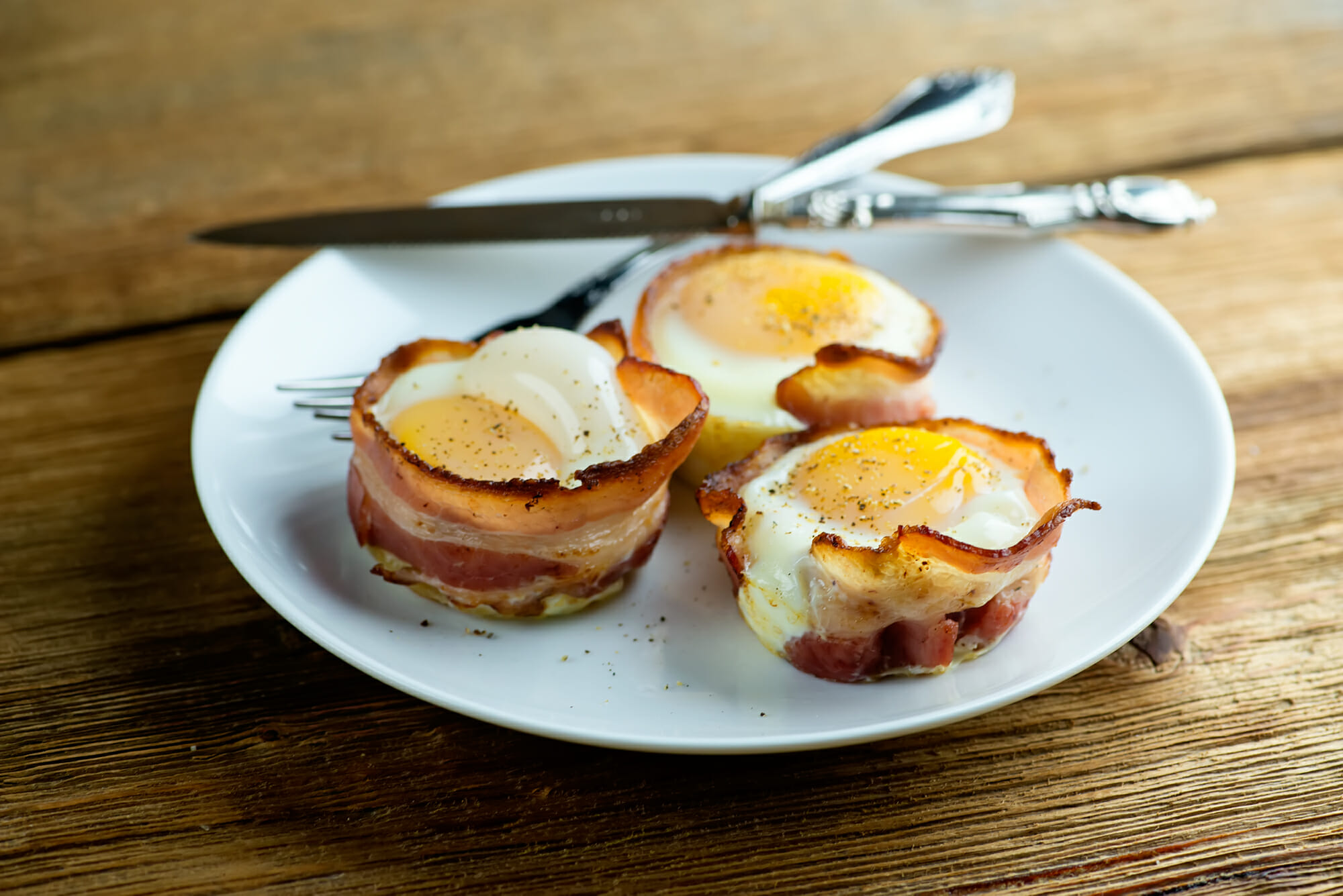 Bacon egg and cheese muffins on a plate.