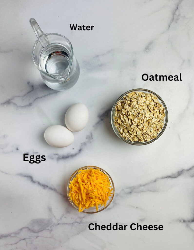 Ingredients for savory oatmeal with eggs on a marble counter.