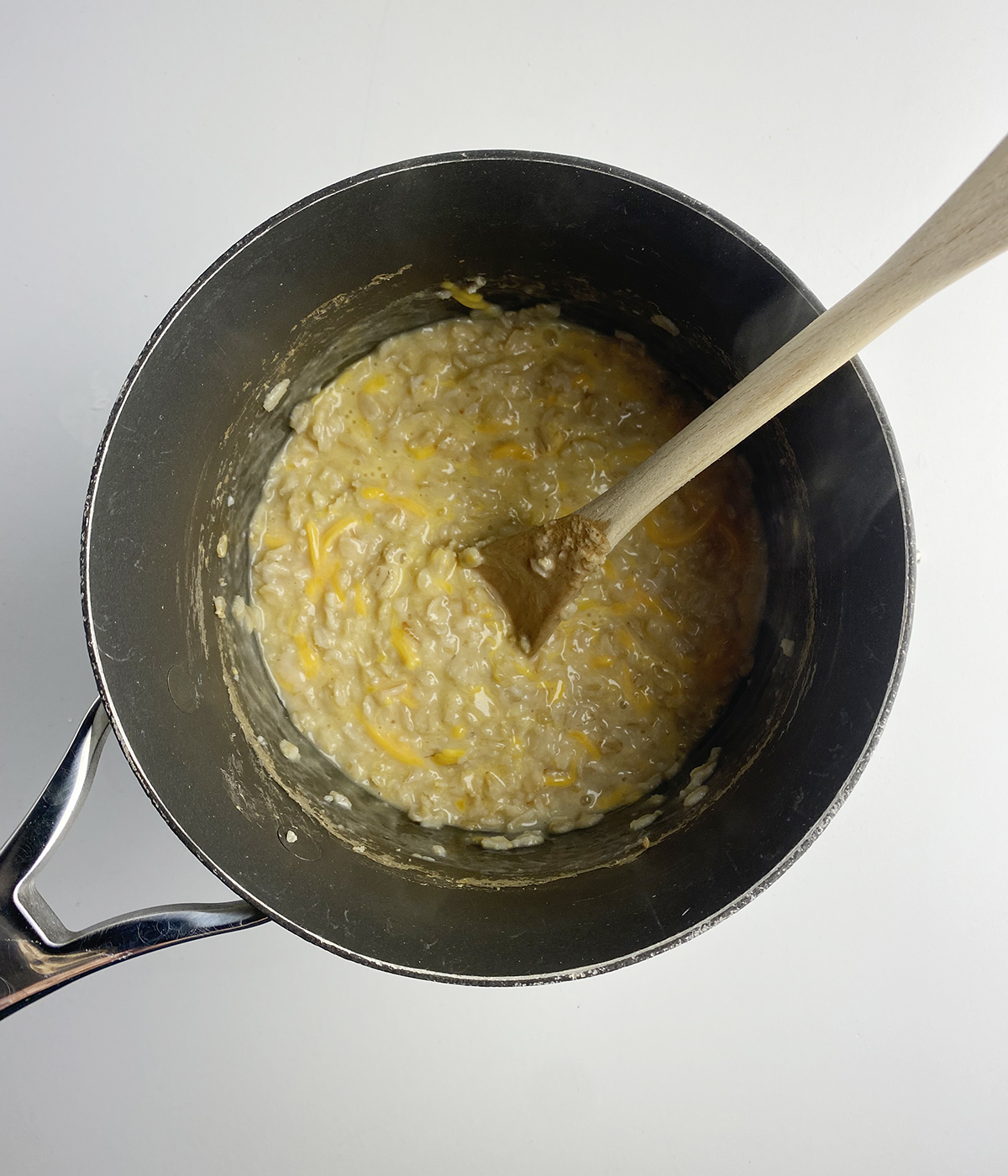 Savory oatmeal with cheese in a pot.